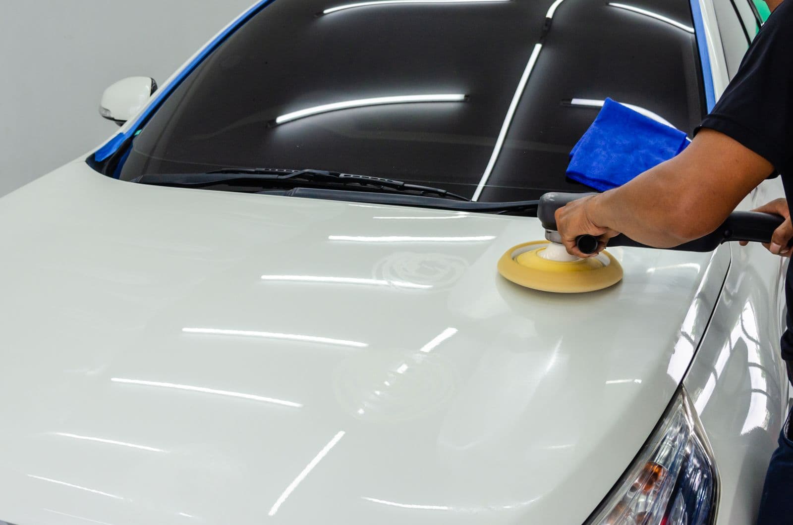 Machine polishing a white hood to a wet gloss before protection is applied